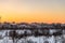 Evening winter sunset over suburban houses on horizont. Belgorod Region, Russia.