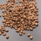 Evenly scattered coffee beans on a black background.