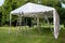 Event tent set up  with ladders on the lawn in a park for a summer party or wedding