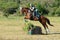 Eventers jumping cross-country course