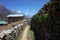 Everest trek, Hiker standing on walkway in Phortse village 3810 m - remote settlement away from main tourist trail. Mountains