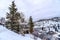 Evergreens and houses on snowy hill in Park City Utah viewed in winter