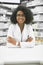 Every customers needs are just as important. Portrait of a cheerful young female pharmacist standing with arms folded