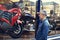 Every mans dream. a mature man admiring the window display of a motorcycle shop.