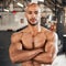 Every muscle is worth the price. a young man taking a break during a workout.