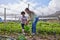 Every plant needs water to grow. Full length shot of an attractive young woman and adorable little boy working on a farm