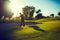 Every shot counts. a young man hitting the ball out of the bunker during a round of golf.