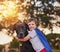 Every superhero needs a super dog. Shot of a little boy and his dog wearing capes while playing outside.