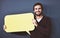 Every thought counts. Studio portrait of a young man holding a speech bubble against a grey background.