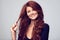 Every woman wants strong hair. Studio shot of a young woman with beautiful red hair posing against a gray background.