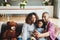 Everybody put on your biggest smile. a happy young family of three taking selfies together in their living room at home.