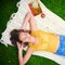 Everyone deserves a day off. a carefree young woman relaxing on a blanket in the park.