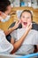 Everything is looking good in there. a female dentist examining a young girls teeth.