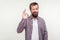 Everything is ok! Portrait of optimistic bearded young man winking at camera and showing okay gesture.  on white