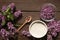 Everything prepared for homemade lilac sugar - Purple lilac flower, wooden spoon, sugar