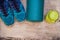Everything for sports turquoise, blue shades on a wooden background and spinach smoothies. Yoga mat, sport shoes