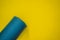 Everything for sports turquoise, blue shades on a yellow background. Yoga mat, sport shoes sportswear and bottle of