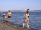 Evia Island, Greece. July 2019: Boy and girl playing frescobol on the beach - beach tennis - wooden rackets and ball on a Sunny su