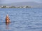 Evia Island, Greece. July 2019: Tourists and vacationers swim in the Aegean sea and relax on the beach on a summer day on a Greek