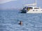 Evia Island, Greece. July 2019: Tourists and vacationers swim in the Aegean sea and relax on the beach on a summer day on a Greek