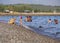 Evia Island, Greece. July 2019: Tourists and vacationers swim in the Aegean sea and relax on the beach on a summer day on a Greek