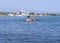 Evia Island, Greece. July 2019: Tourists and vacationers swim in the Aegean sea and relax on the beach on a summer day on a Greek