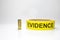Evidence tape with brass bullet case on white background