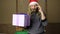 Evil dwarf or bad santa holding a gift in celebratory packing