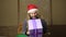 Evil dwarf or bad santa holding a gift in celebratory packing