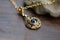 evil eye charm, dangling from delicate gold chain