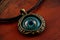 evil eye pendant on leather cord, worn as necklace