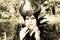 Evil fairy tale, maleficent, malevolent queen with horns and crow feather gown