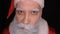 Evil Santa Claus grimaces and scares a terrible face