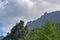 Evocative alpine panorama with clouds and mountains trees