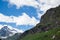 Evocative alpine panorama with clouds and mountains trees