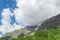 Evocative alpine panorama with clouds and mountains trees