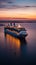 An evocative shot of a cruise ship departing from port at sunset