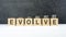 evolve word, text written on wooden cubes on a black background with coins on cubes