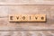 EVOLVE word written on wood block. EVOLVE text on wooden table for your desing, concept
