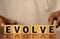 EVOLVE word written on wood block. EVOLVE text on wooden table for your desing, concept