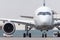 Exactly front view of the cockpit and nose, wing and engine of the aircraft at the airport