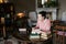 Exam preparation. Student girl in glasses and a pink sweater leaned over books, engaged in an old library at the table.