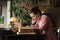 Exam preparation. Student girl in glasses and a pink sweater leaned over books, engaged in an old library at the table.