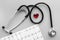 Examine the heart to prevent heart disease. Heart sign, cardiogram, stethoscope on grey background top view