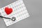 Examine the heart to prevent heart disease. Heart sign, cardiogram, stethoscope on grey background top view copyspace