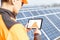 Examining production of solar power plant with digital tablet