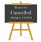 Exams are cancelled owing to covid-19 on a blackboard and easel - Vector EPS illustration