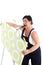 Exasperated woman hanging wallpaper