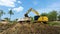 excavating soil into a dump truck to build a pond for store water for use in the dry season for agriculture