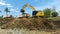 excavating soil into a dump truck to build a pond for store water for use in the dry season for agriculture